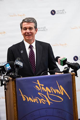 Governor Cooper at the podium